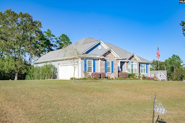 view of front of home with a garage and a front lawn