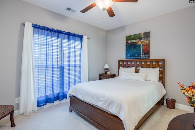 bedroom with light colored carpet and ceiling fan