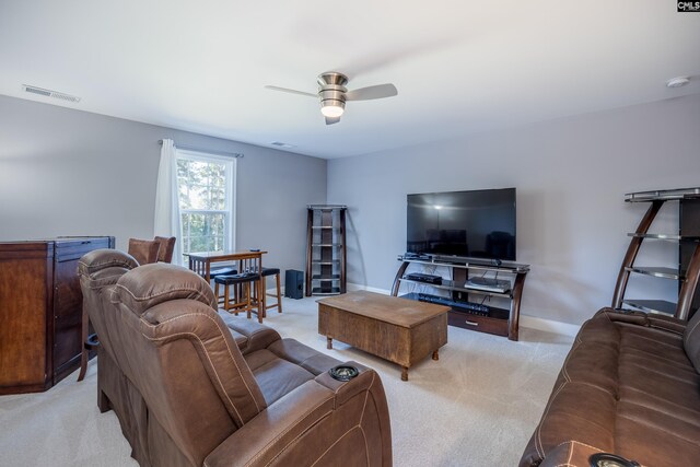 carpeted living room featuring ceiling fan