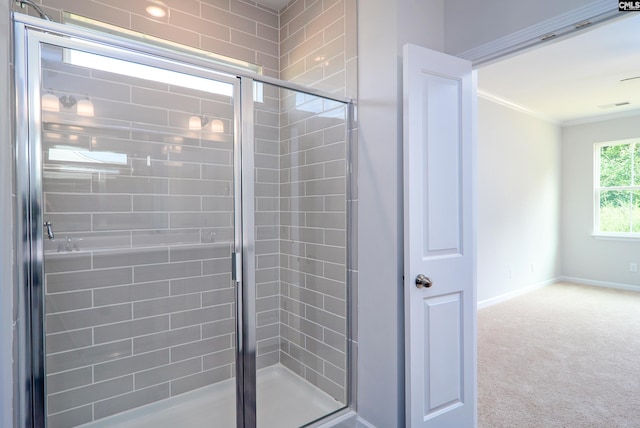 bathroom with walk in shower and ornamental molding