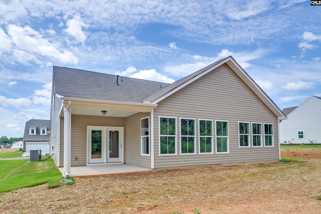 back of house with a patio, cooling unit, and a lawn