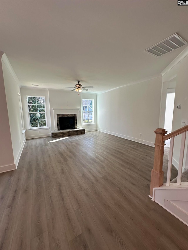 unfurnished living room featuring ceiling fan, crown molding, and dark hardwood / wood-style floors