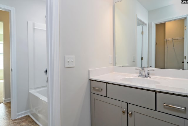 bathroom featuring vanity, hardwood / wood-style flooring, and a washtub