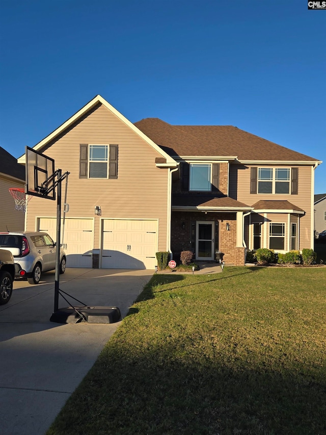 view of front of home featuring a front yard and a garage