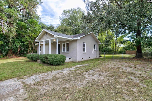 view of side of property with a lawn