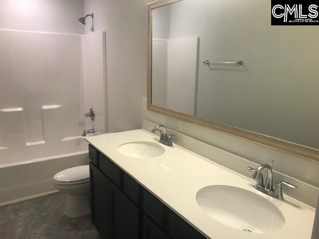 full bathroom featuring toilet, vanity, and bathing tub / shower combination