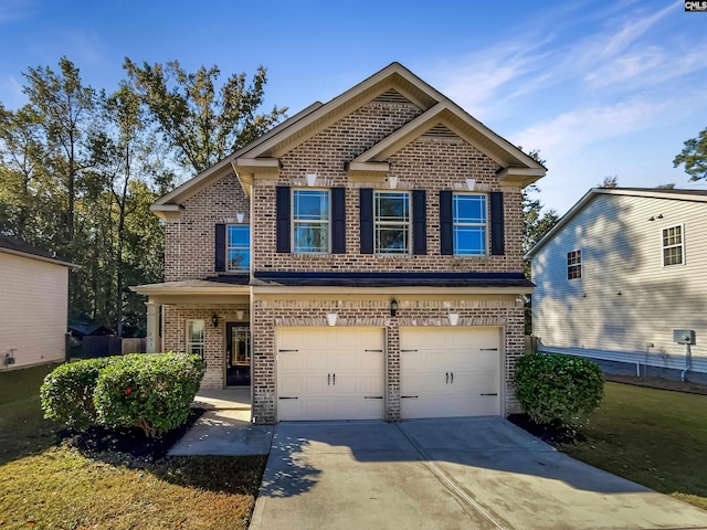 view of front of home with a garage and a front lawn