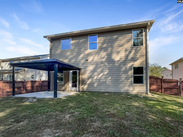 rear view of house with a yard and a patio area