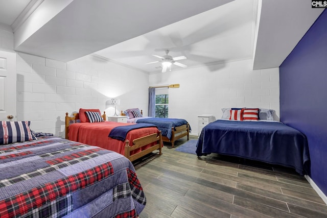 bedroom featuring crown molding, ceiling fan, and dark hardwood / wood-style flooring