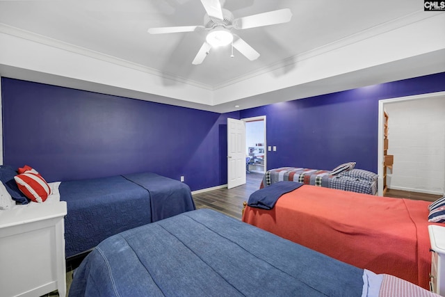 bedroom featuring dark hardwood / wood-style flooring, crown molding, ensuite bathroom, and ceiling fan