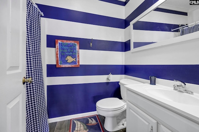 bathroom with walk in shower, wood-type flooring, toilet, ornamental molding, and vanity