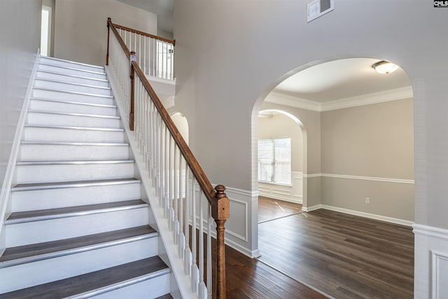 stairway featuring ornamental molding and hardwood / wood-style floors