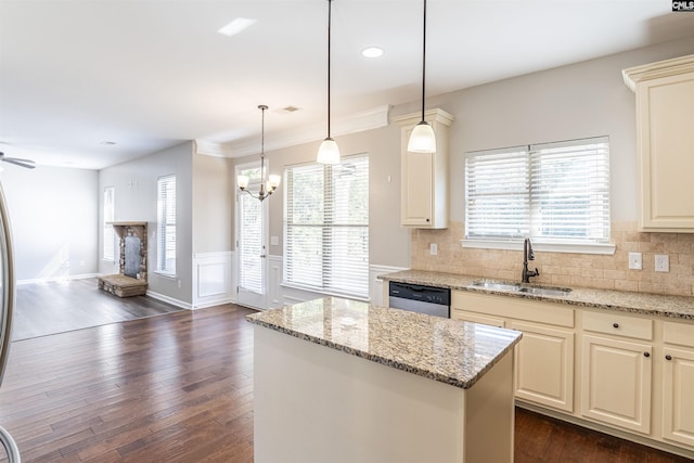 kitchen with a center island, light stone countertops, sink, and dark hardwood / wood-style flooring