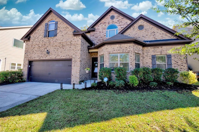 view of front of home featuring a front yard and a garage