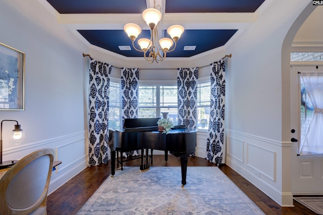 interior space featuring an inviting chandelier, ornamental molding, and dark wood-type flooring