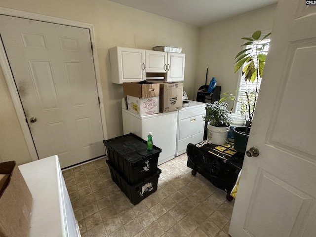 laundry room featuring washer and dryer and cabinets