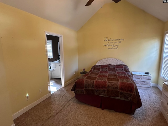 bedroom featuring lofted ceiling, carpet floors, ensuite bath, and ceiling fan