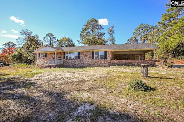 ranch-style house featuring a porch and a front yard