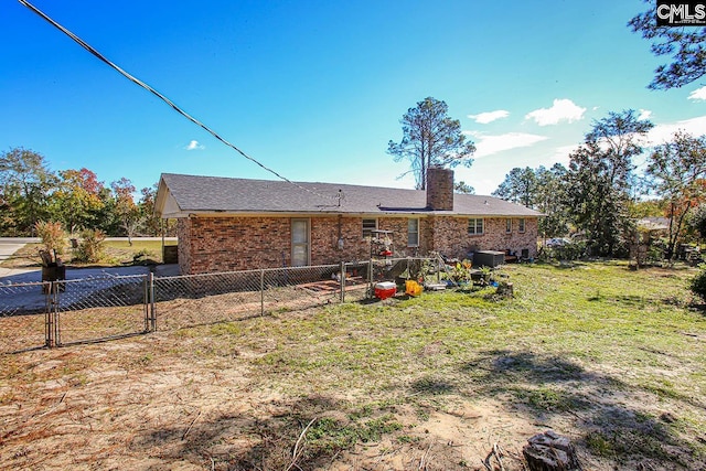 rear view of house featuring a yard