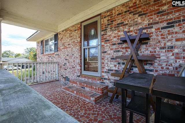 view of exterior entry with a porch