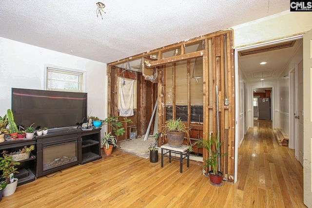 interior space featuring wood-type flooring and a textured ceiling