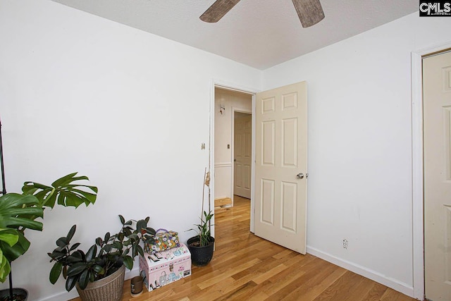 interior space featuring a textured ceiling and light wood-type flooring