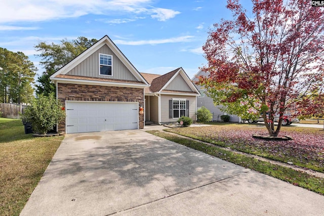 view of front of home with a front yard and a garage