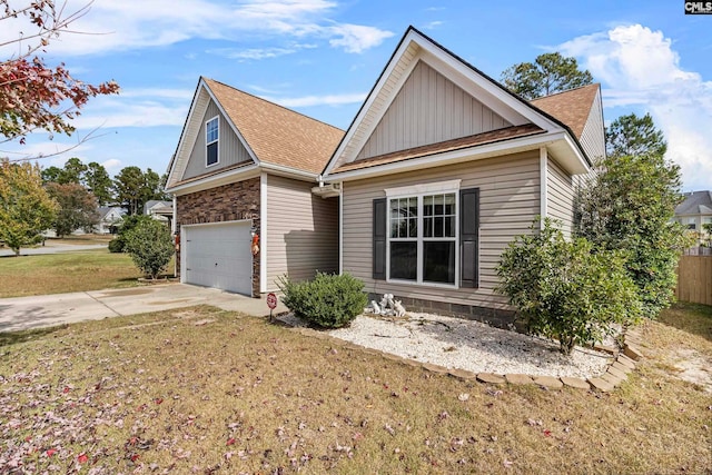 view of front of property featuring a garage and a front lawn