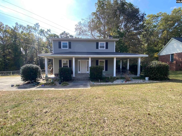 view of front of house featuring covered porch and a front lawn