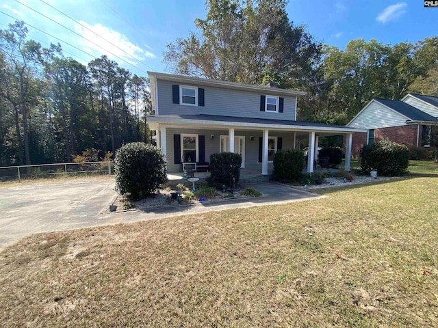 front of property featuring covered porch and a front yard