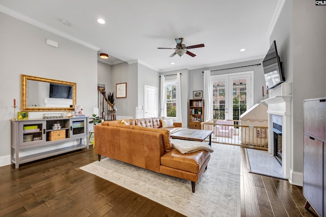 living room featuring crown molding, french doors, dark wood-type flooring, and ceiling fan