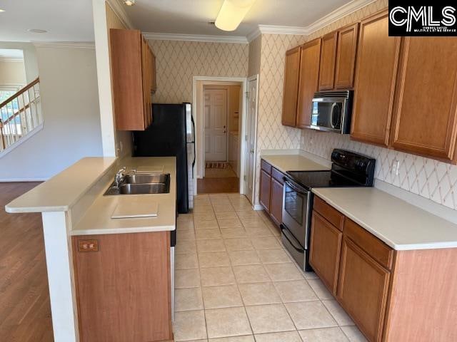 kitchen featuring kitchen peninsula, sink, black appliances, crown molding, and light tile patterned floors