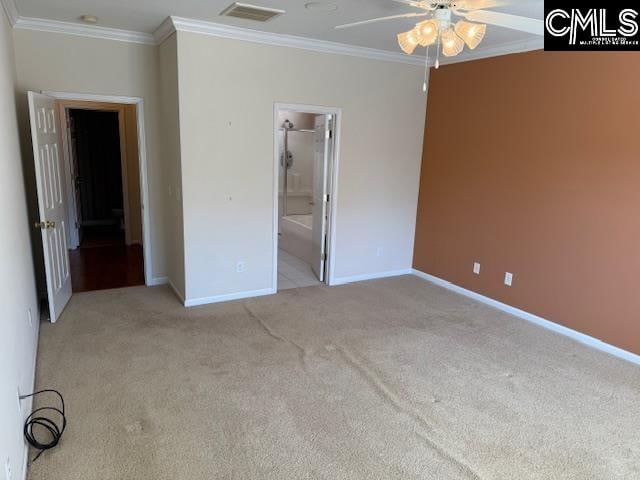 unfurnished bedroom with ensuite bathroom, ornamental molding, light colored carpet, and ceiling fan