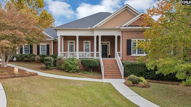 4 High Park Ct, Elgin, SC 29045 - neoclassical home with brick siding, a porch, a front yard, and stairs
