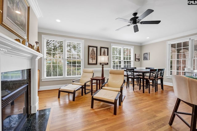 4 High Park Ct, Elgin, SC 29045 - dining room with crown molding, a high end fireplace, baseboards, light wood-style flooring, and a ceiling fan