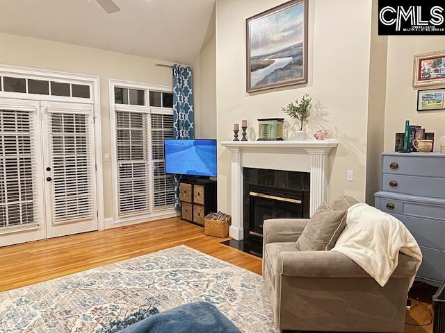 4 High Park Ct, Elgin, SC 29045 - living room featuring wood finished floors, a fireplace with flush hearth, lofted ceiling, and a ceiling fan