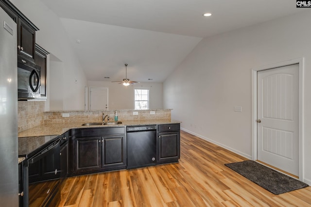 410 Pitchling Dr, Columbia, SC 29223 - kitchen featuring light wood-type flooring, a sink, black appliances, a peninsula, and lofted ceiling