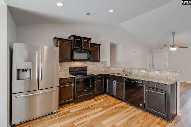 410 Pitchling Dr, Columbia, SC 29223 - kitchen featuring lofted ceiling, light wood-type flooring, tasteful backsplash, a sink, and black appliances