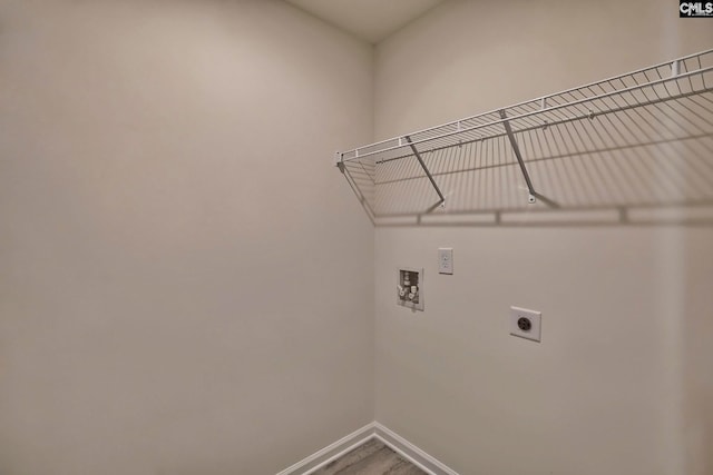 laundry room featuring electric dryer hookup, hookup for a washing machine, and wood-type flooring