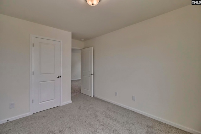 unfurnished room with light carpet