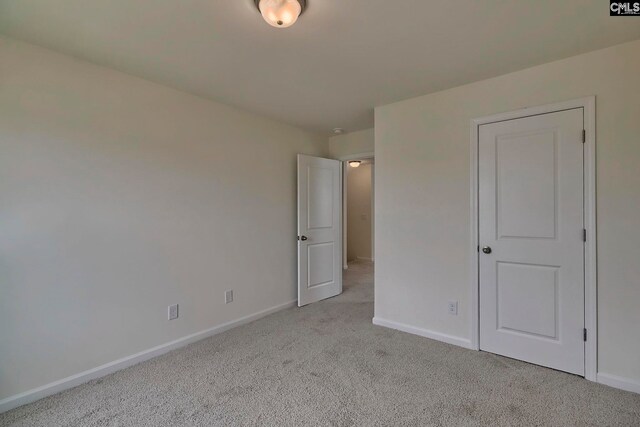 unfurnished bedroom featuring light colored carpet