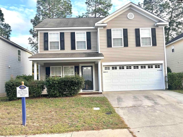 traditional home with a front lawn, an attached garage, and driveway