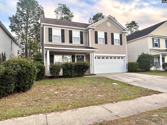 view of front of property featuring a lawn and a garage