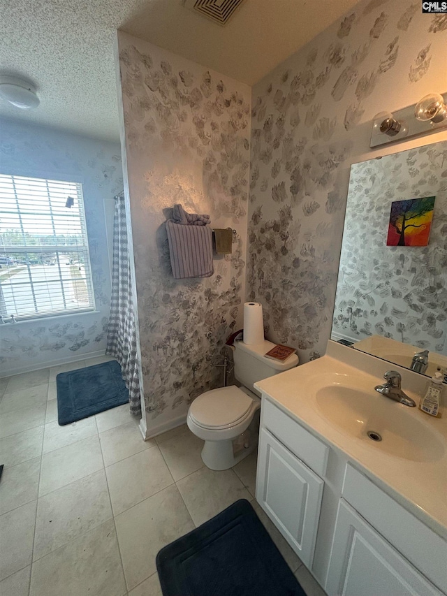 bathroom featuring tile patterned floors, visible vents, toilet, wallpapered walls, and vanity