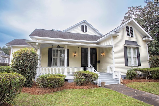 view of front of home with a front yard, ceiling fan, and a porch