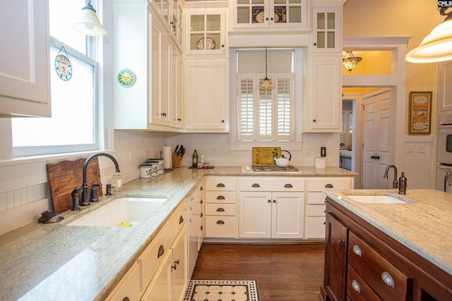 kitchen featuring a healthy amount of sunlight, sink, and hanging light fixtures