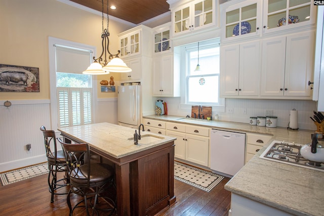 kitchen with white appliances, white cabinetry, an island with sink, and dark hardwood / wood-style floors