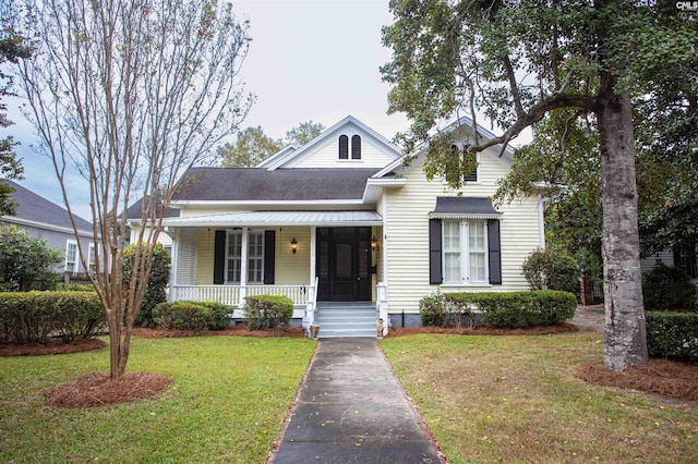 view of front of house with covered porch and a front yard