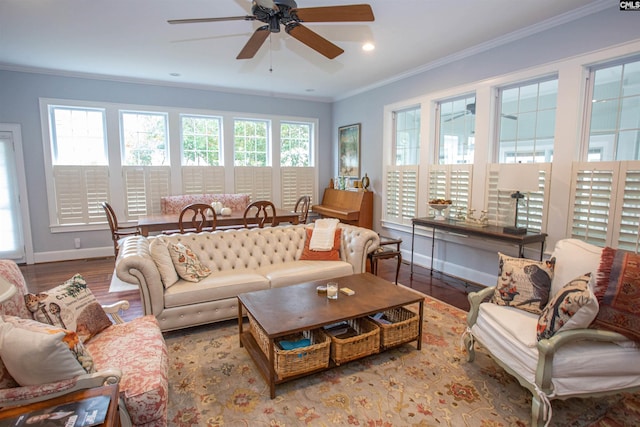 living room featuring light hardwood / wood-style floors, ornamental molding, and ceiling fan