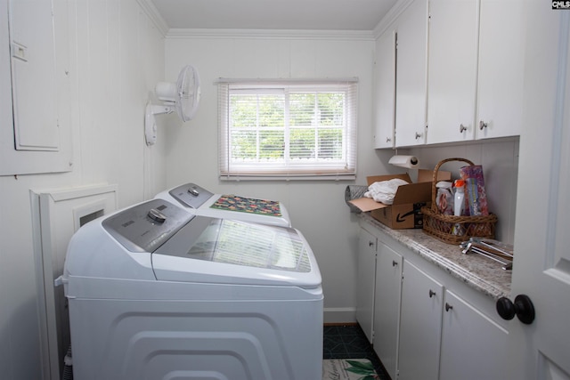 clothes washing area with cabinets, crown molding, electric panel, and washer and clothes dryer